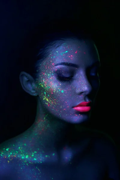 Close-up black female with fluorescent prints on skin, cosmic paint glowing  on neon lights Stock Photo by ©ufabizphoto 543170308