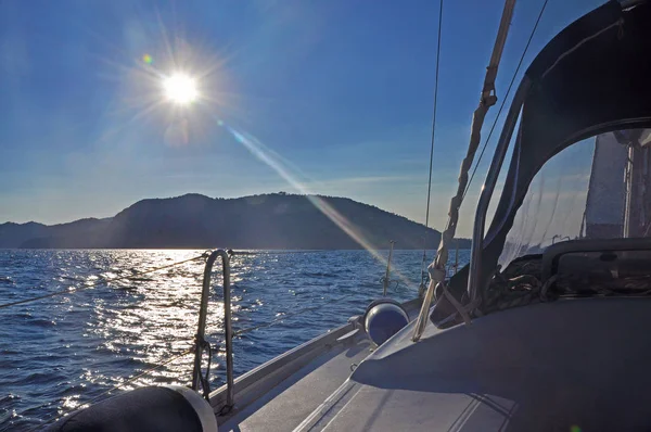 Der Blick von der Jacht auf die Insel gegen das Sonnenlicht — Stockfoto