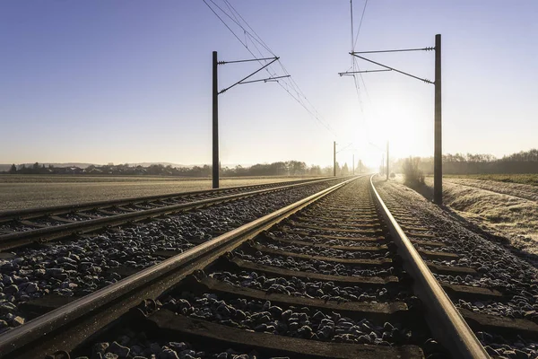 Eisenbahngleise und frostige Landschaft. Bahngleise bei Sonnenaufgang — Stockfoto