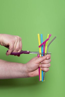 Cutting plastic straws. Metal drinking straw. Reduce plastic was clipart
