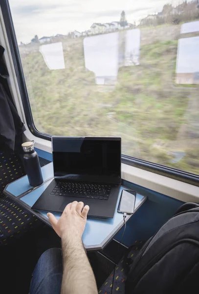 Using laptop on train travel. Train interior. Business commuting