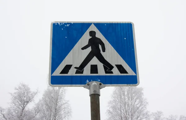 Pedestrian crossing road sign on winter sky background. — Stock Photo, Image