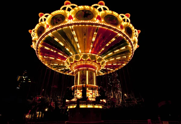 Renkli zinciri hareket eğlence parkı gece atlıkarınca salıncak.