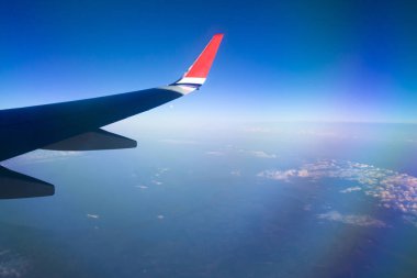 Mavi gökyüzü ve beyaz bulutlu uçak penceresinden bak.