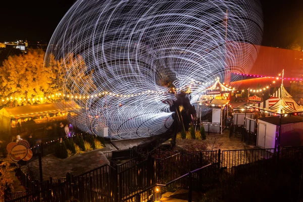 Helsinki, Finland - 19 October 2019: The Carnival of Light event at the Linnanmaki amusement park. Ride Magia in motion, night illumination. Long exposure. — ストック写真