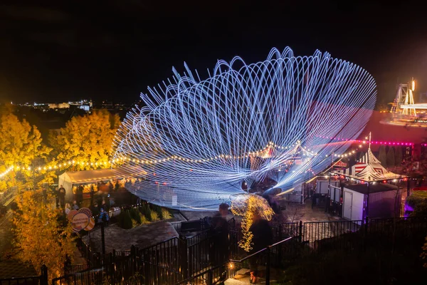 Helsinki, Finland - 19 October 2019: The Carnival of Light event at the Linnanmaki amusement park. Ride Magia in motion, night illumination. Long exposure. — ストック写真