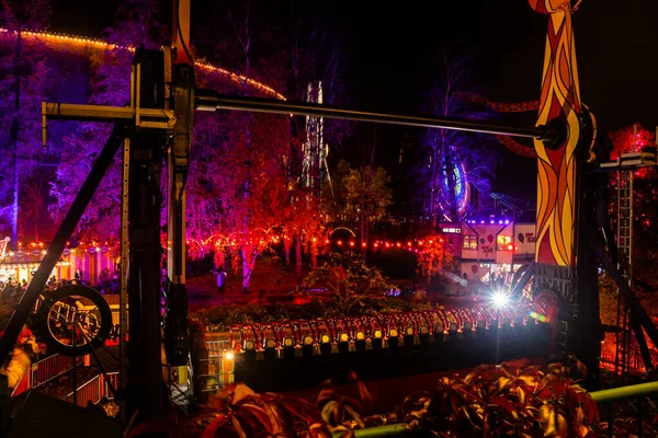 Helsinki, Finland - 19 October 2019: The Carnival of Light event at the Linnanmaki amusement park. Ride Kieputin. Night illumination. — ストック写真