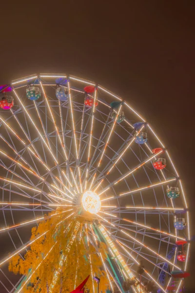 Rueda de la fortuna en el parque de atracciones, iluminación nocturna . — Foto de Stock