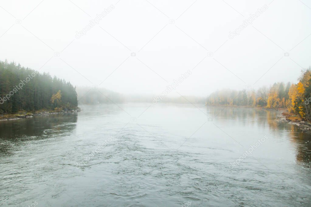 Beautiful autumn landscape of Kymijoki river waters in fog. Finland, Kymenlaakso, Kotka