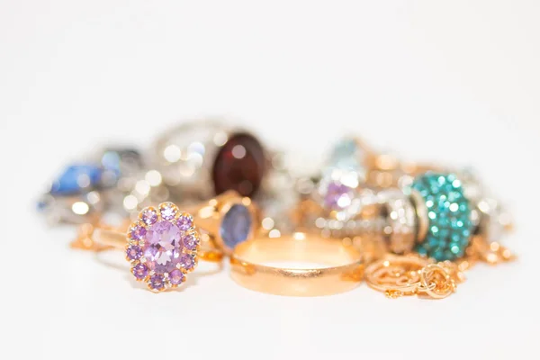 Συλλογή από κοσμήματα με όμορφο χρυσό δαχτυλίδι με μωβ πέτρα που απομονώνονται σε λευκό φόντο — Φωτογραφία Αρχείου