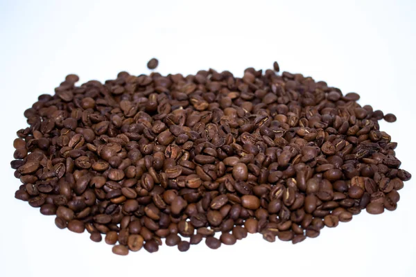 Roasted coffee beans pile isolated on white background. Selective focus.