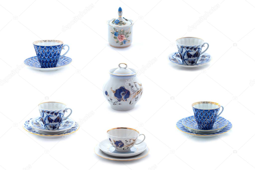 Collection of porcelain tea cups and dishes with flower ornament. Full size.