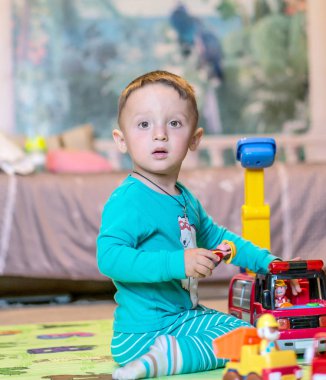 Küçük çocuk ahşap yangın istasyonu ile evde oynarken