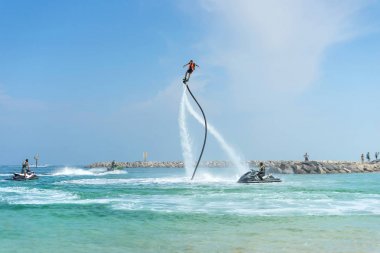 Adam Karayip tropik sahilde yeni flyboard, poz. Pozitif