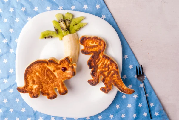 Funny food for kids: Pancake in the form of dinosaurs