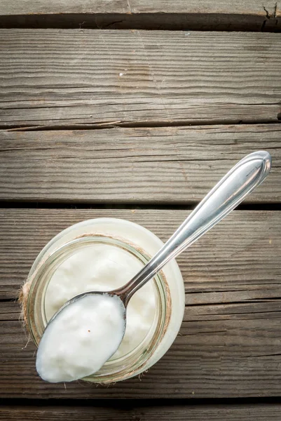 Yogur orgánico casero en un frasco con una cuchara — Foto de Stock