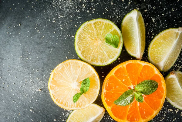 Fresh citrus fruits on a black slate table — Stock Photo, Image