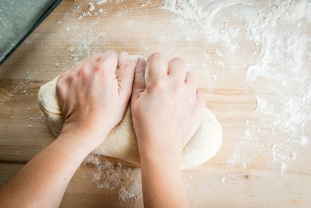 Girl makes homemade cinnamon buns or bread