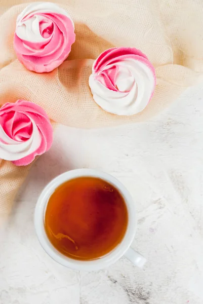 Cakes in the form of flowers and tea