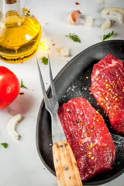 Maso, hovězí maso. Čerstvé syrové steaky v pánvi. Koření (sůl, pepp — Stock fotografie