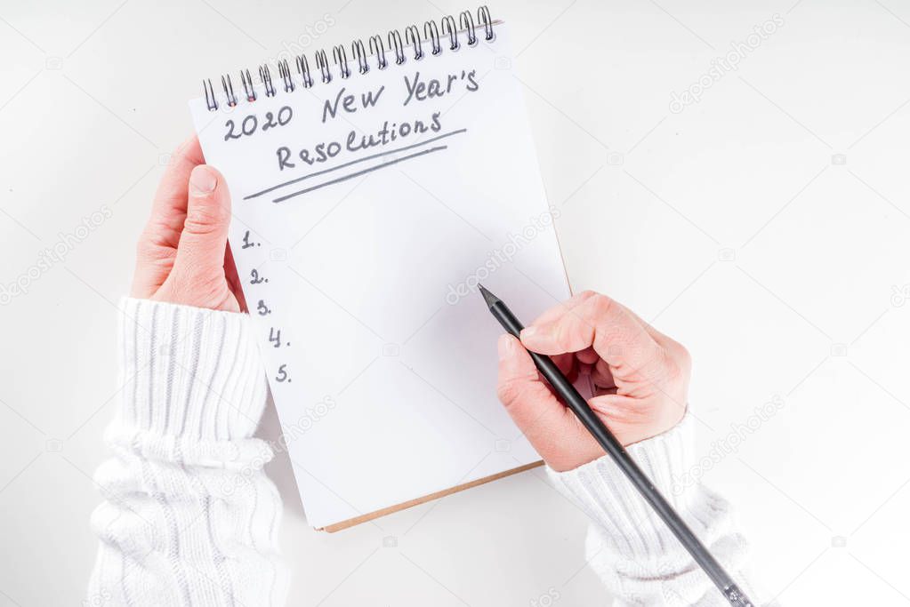 Woman hands write new year goals
