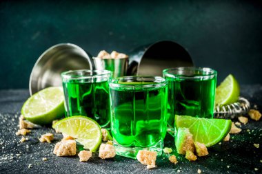 Three shot glasses with absinthe