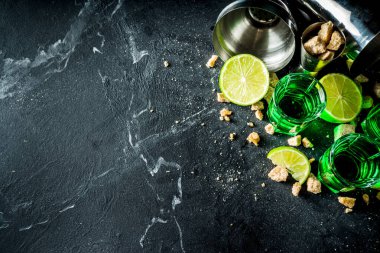 Three shot glasses with absinthe