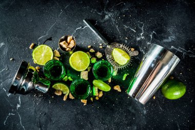 Three shot glasses with absinthe