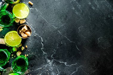 Three shot glasses with absinthe