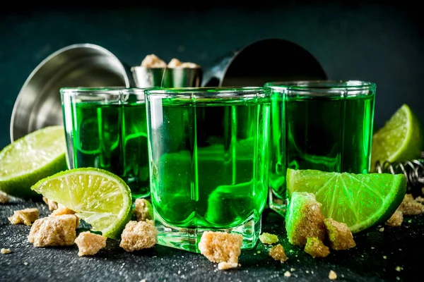 Three shot glasses with absinthe