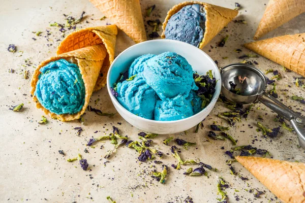 Trendy Color Changing Ice Cream with blue flowers powder, Butterfly Pea Flower Blossom gelato with ice cream waffle cones