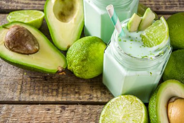 Avokado Milk Shake ya da Smoothie, Avokado ve Limon Suyu ile Yoğurt, Taze Avokadolar ve ahşap arka plan fotokopi alanı üzerine limonlar