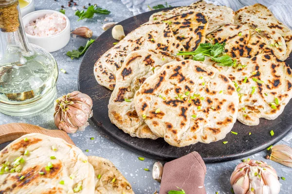 Indian naan flat bread. Indian Indian traditional tortillas pita bread, with herbs, olive oil and garlic.