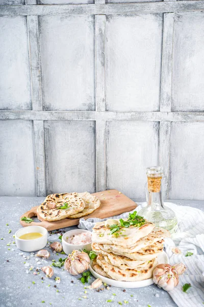 Indian naan flat bread. Indian Indian traditional tortillas pita bread, with herbs, olive oil and garlic.