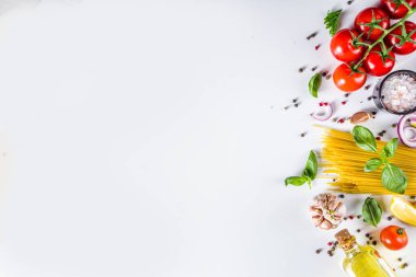 Makarna pişirmek için İtalyan yemekleri. Çeşitli malzemeli çiğ spagetti makarna - soğan, domates, sarımsak, fesleğen, maydanoz, peynir, zeytinyağı. Beyaz tablo arkaplanında, düz kopya alanı