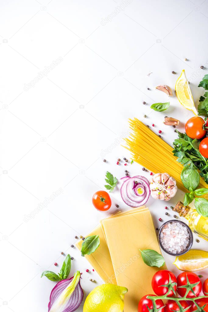 Italian food ingredients for  cooking Spaghetti Pasta. Raw spaghetti pasta with various ingredient - onion, tomatoes, garlic, basil, parsley, cheese, olive oil. On white table background, flatlay copy space