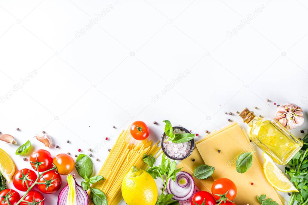 Italian food ingredients for  cooking Spaghetti Pasta. Raw spaghetti pasta with various ingredient - onion, tomatoes, garlic, basil, parsley, cheese, olive oil. On white table background, flatlay copy space