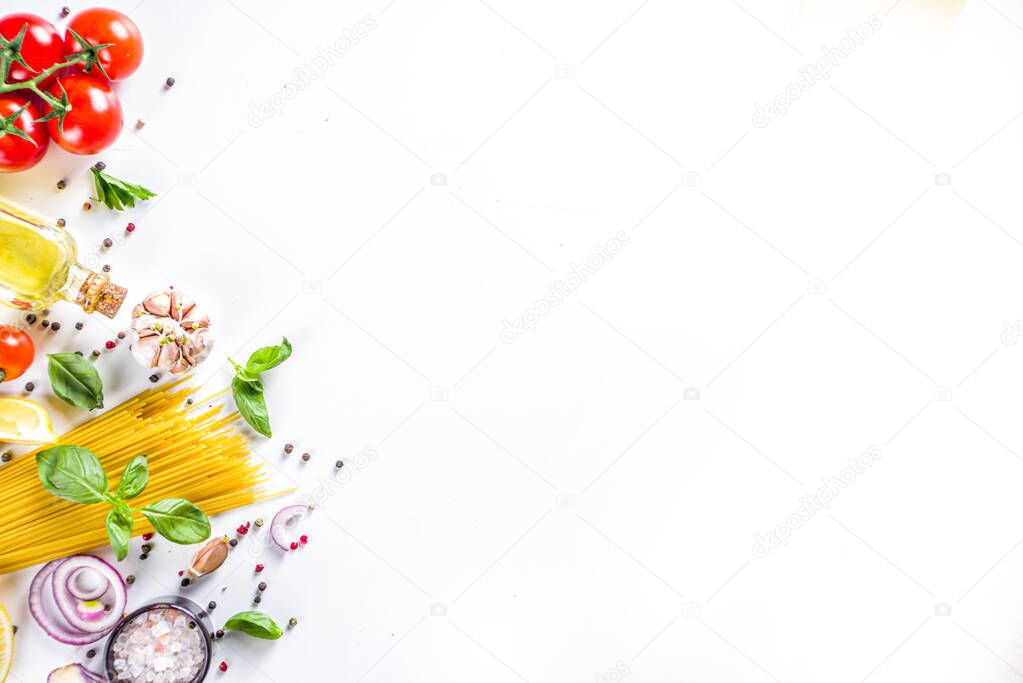 Italian food ingredients for  cooking Spaghetti Pasta. Raw spaghetti pasta with various ingredient - onion, tomatoes, garlic, basil, parsley, cheese, olive oil. On white table background, flatlay copy space