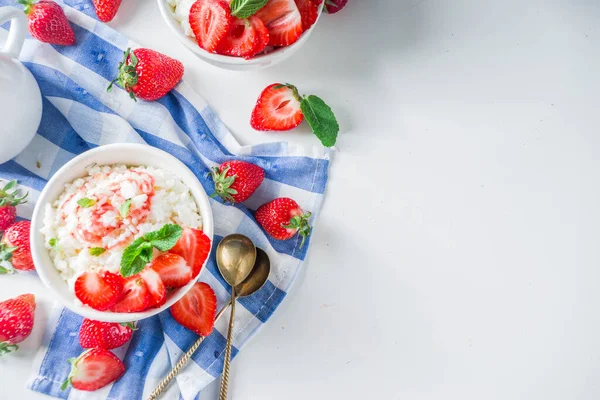Summer morning rice pudding or rice porridge with strawberry and berry syrup in small bowl for, With milk and fresh strawberry copy space