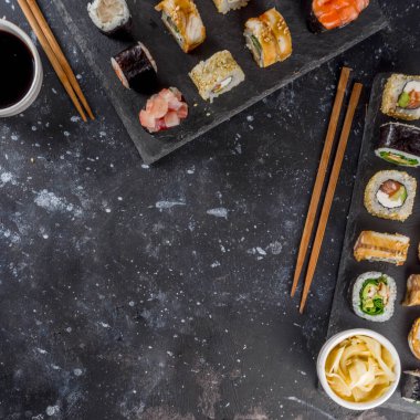 Japon yemeği. Büyük suşi seti. Çeşitli sashimi çeşitleri, maki ve suşi sarmaları farklı dolgularla - ton balığı, levrek, somon, karides, sebze. Düz kopyalama alanı