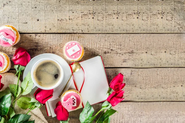 Valentine morning sweetheart scene. Breakfast on Valentine\'s Day February 14th. Sweet creative cupcakes with whipped cream and decor love, Valentine symbols. Mockup flatlay top view copy space