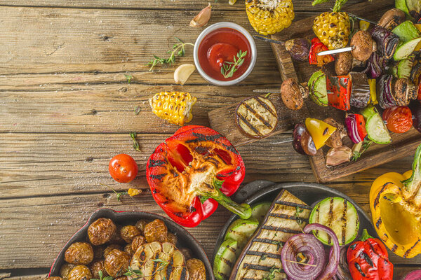 Assortment various barbecue vegan food, set of grill veggies, vegetable bbq party fest, grilled corn, vegan skewers kebabs, hot vegetable salad, with sauces & spices. Vegetarian seasonal summer food