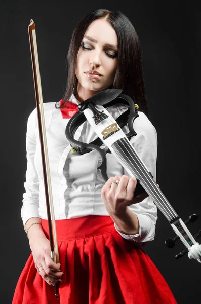 Mulher calma tocando violino em um fundo preto — Fotografia de Stock