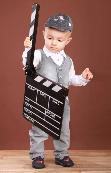 Cute little boy with cinema clapper — Stock Photo, Image