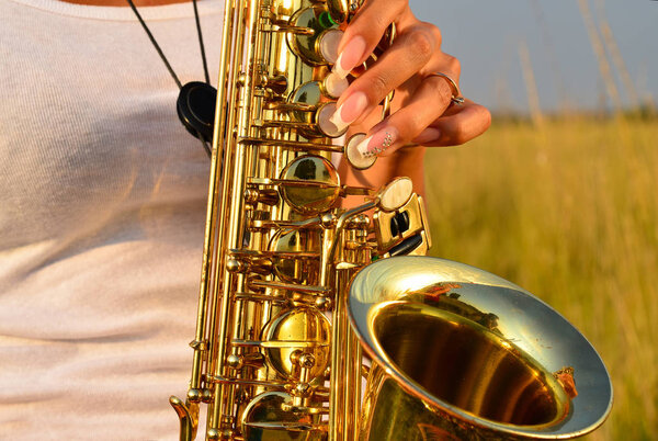 Women's hands and saxophone