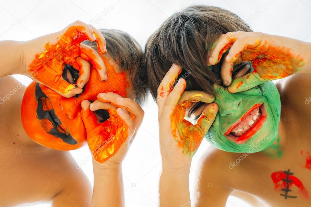 Cute happy children with hands and face painted colors