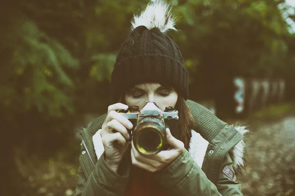 Frau schaut mit seinem alten Kamerafoto — Stockfoto