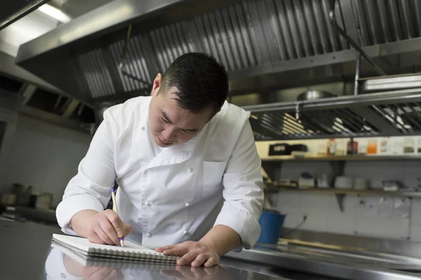 Chinese cook with notebook