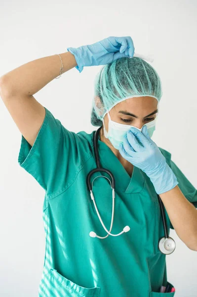 Femeie asistentă medicală care leagă o mască chirurgicală — Fotografie, imagine de stoc
