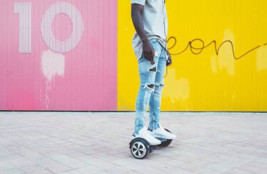 boy driving a hoverboard or self-balancing scooter clipart